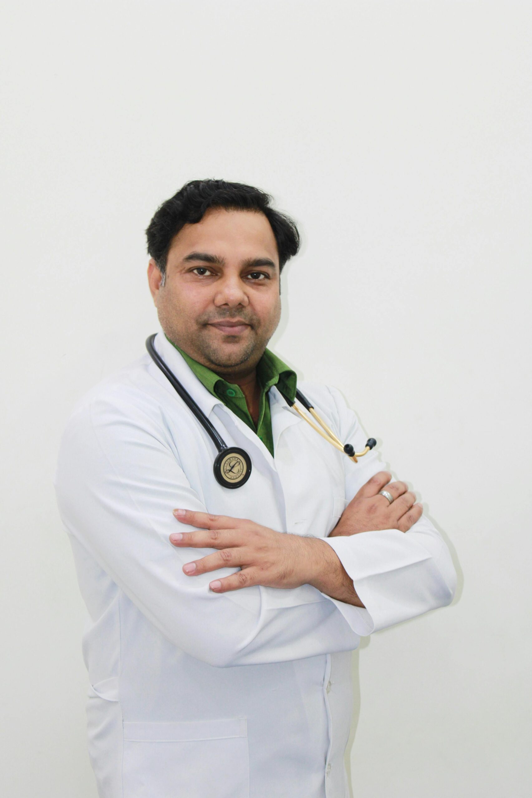 Portrait of a confident male doctor in a clinic environment, wearing a lab coat and stethoscope.